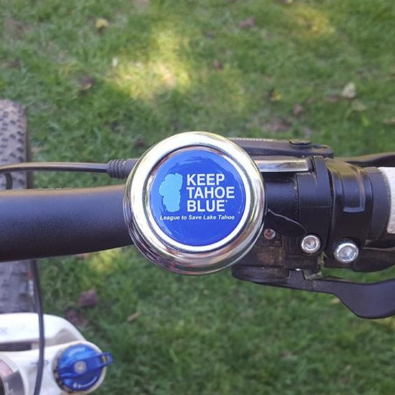 Round metal Keep Tahoe Blue bicycle bell on mountain bike handle bars