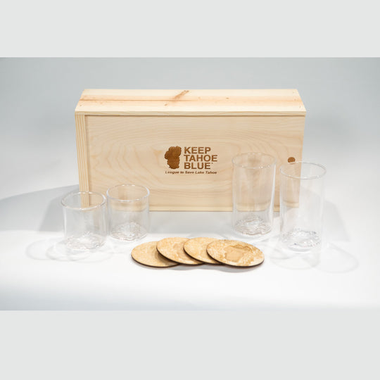 Pine box with laser etched Keep Tahoe Blue logo with two pints, two rocks glasses, and four coasters.