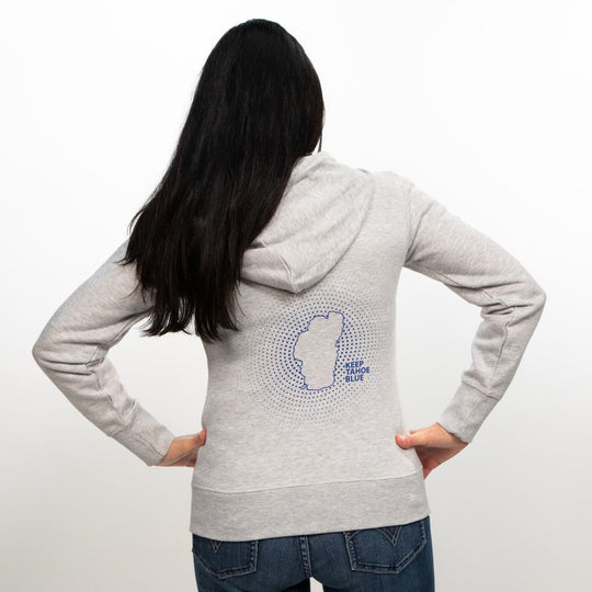 shape of Lake Tahoe with radiating circles and Keep Tahoe Blue logo on back of heather gray zip up sweater