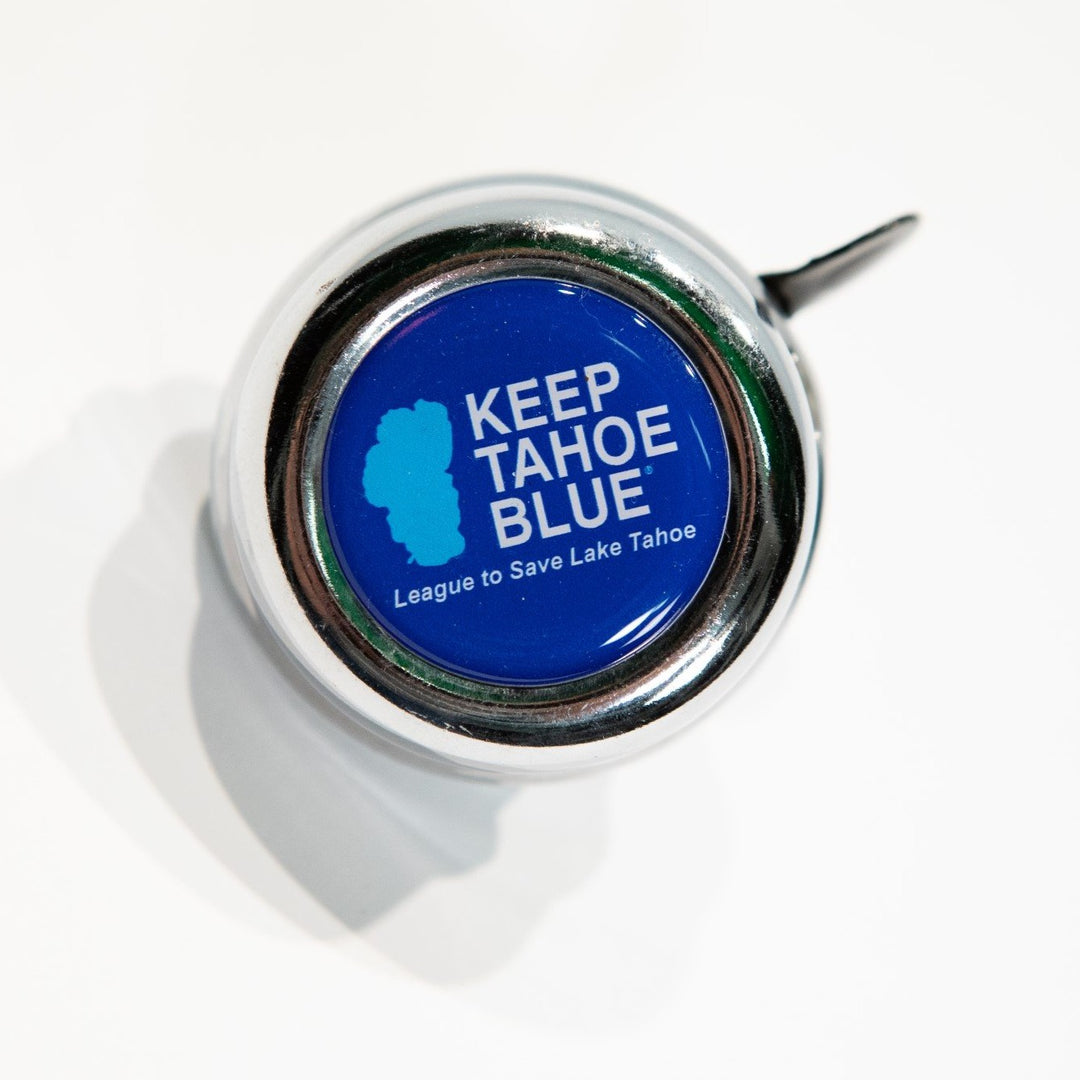 Round silver tone metal bike bell with Keep Tahoe Blue logo