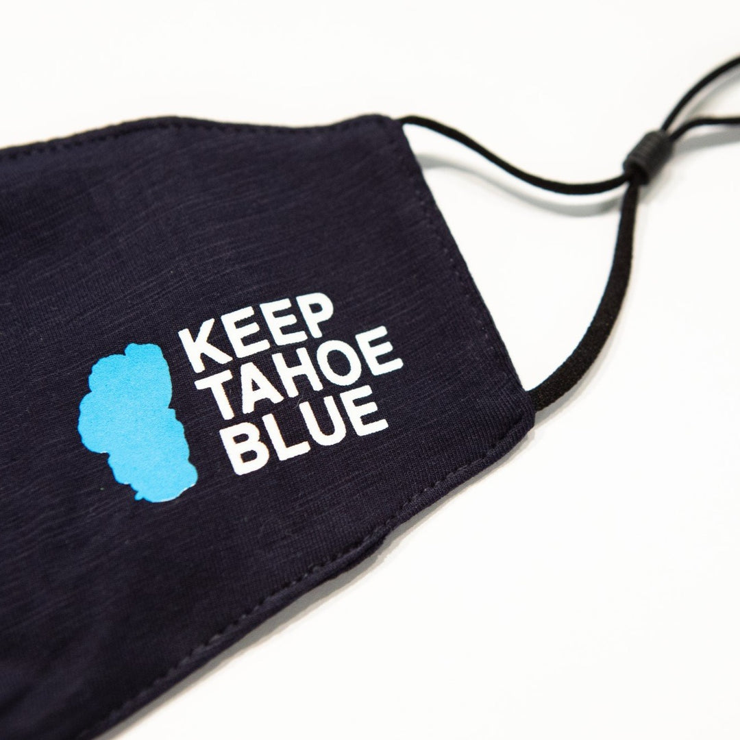 close up of Keep Tahoe Blue logo on navy blue face covering