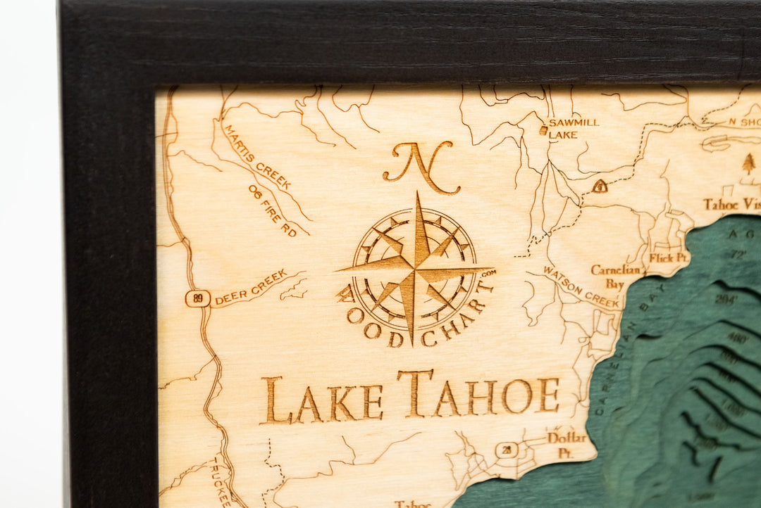 close up of compass rose on Lake Tahoe wood chart