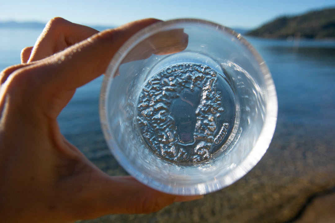 holding up Lake Tahoe rocks glass by the Lake to showcase topographic molding